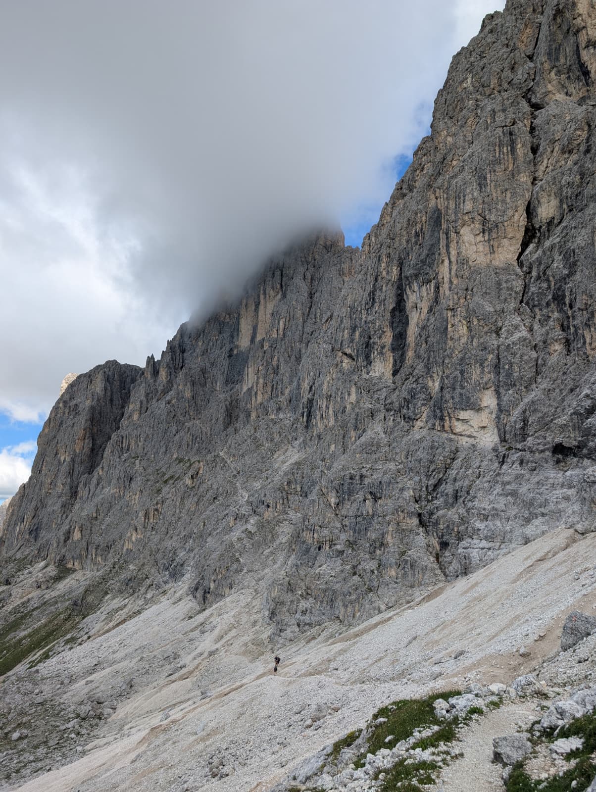 Cloud gathering around a sheer Dolomites rock face