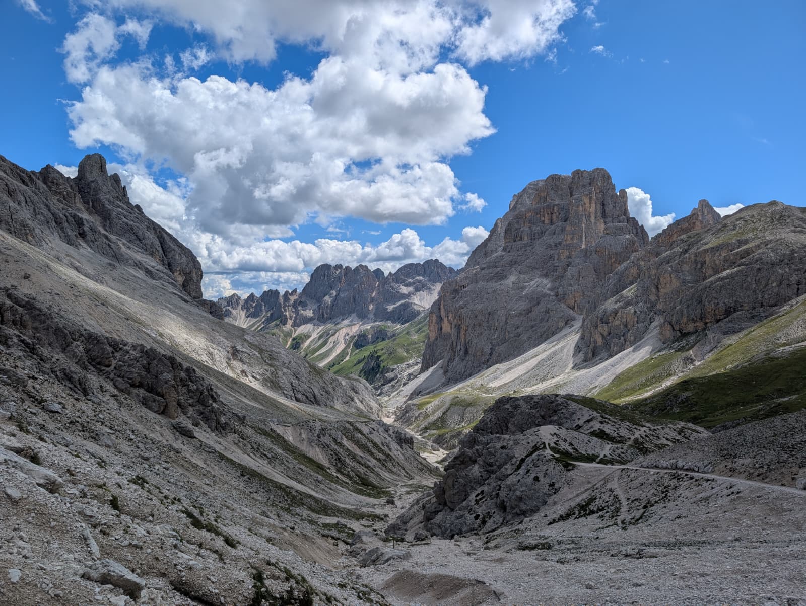 A broad rocky valley beneath the Dolomites peaks