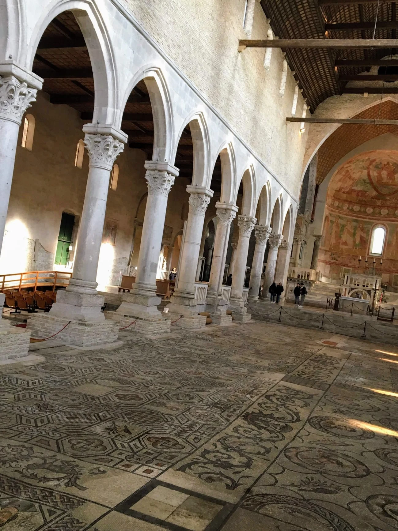 Mosaic floor and columns inside the Basilica of Aquileia